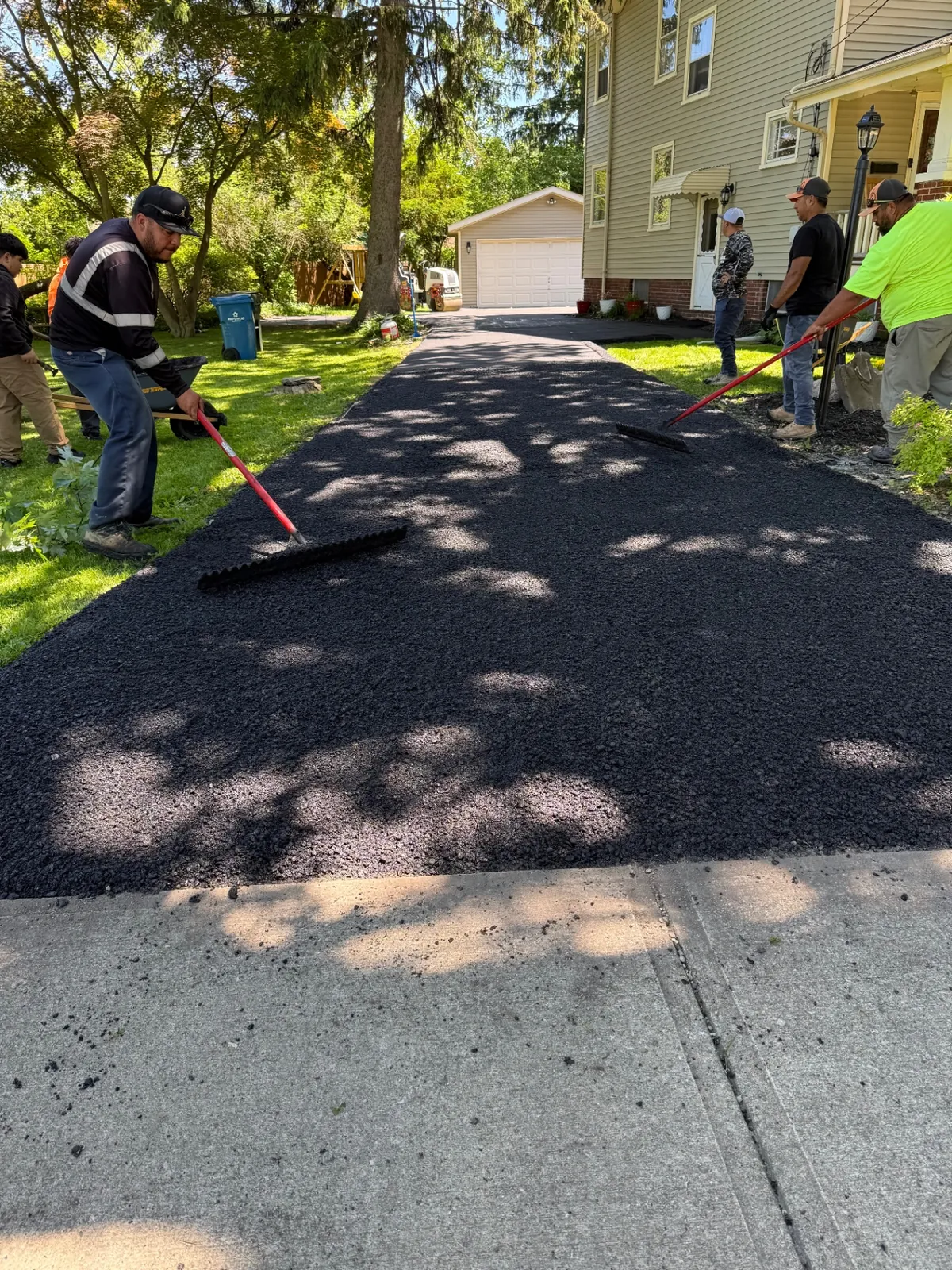Rendon Paving crew installing a fresh asphalt driveway in Painesville, Ohio